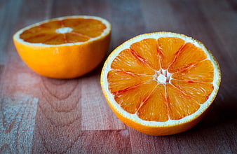 Fresh Blood Orange Halves on Wooden Surface