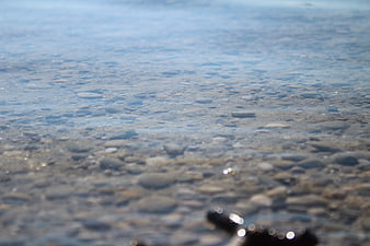 Clear Blue Water Over Smooth Pebbles on Lake Bottom
