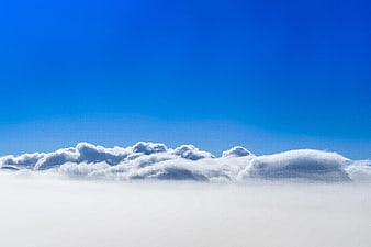Aerial View of Clouds Against Deep Blue Sky