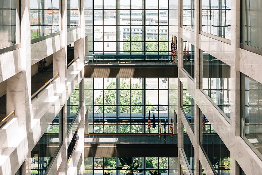 Modern office atrium with marble columns and glass windows