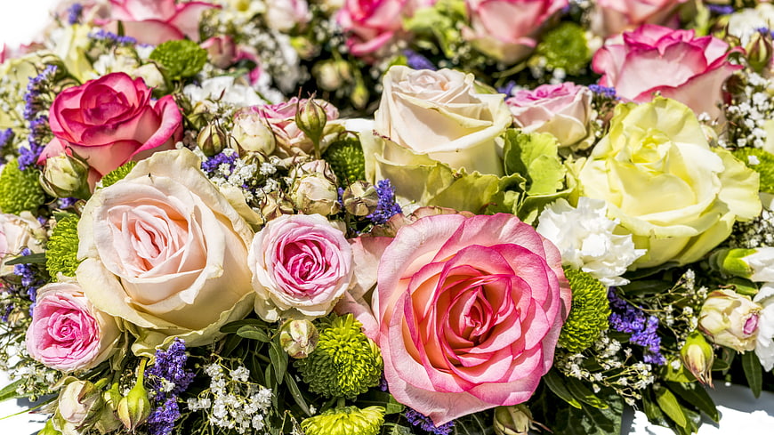 Close-up of vibrant pink, white, and yellow rose bouquet