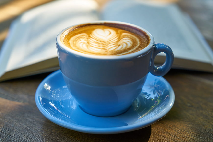 Blue Ceramic Cup of Coffee with Latte Art on Wooden Table