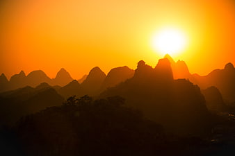 Silhouetted Karst Mountains at Golden Sunset