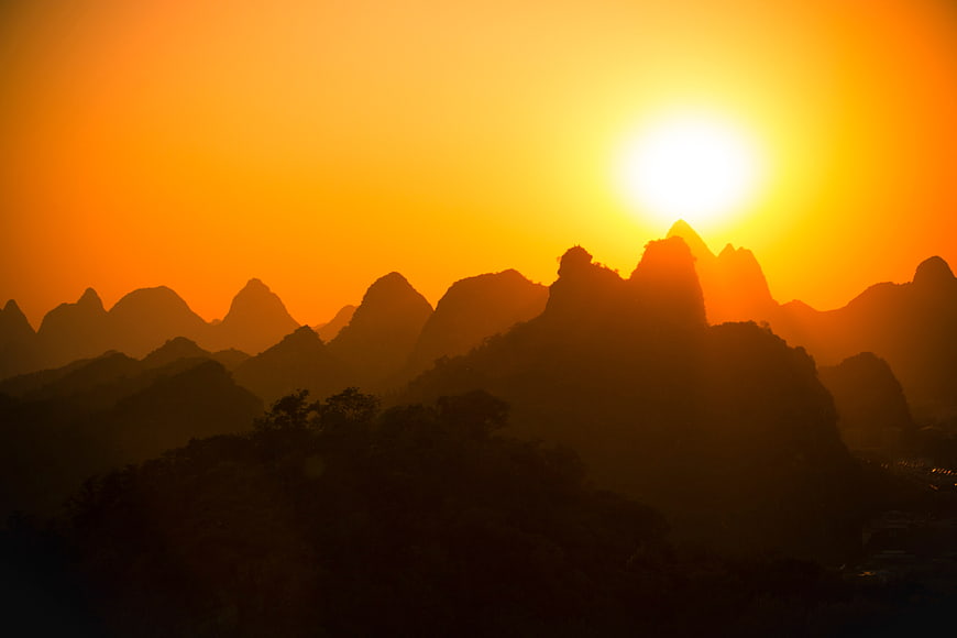 Silhouetted Karst Mountains at Golden Sunset