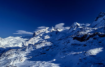 Snowy Mountain Peaks Under Deep Blue Sky