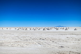 Salt Piles on Uyuni Salt Flats Under Blue Sky