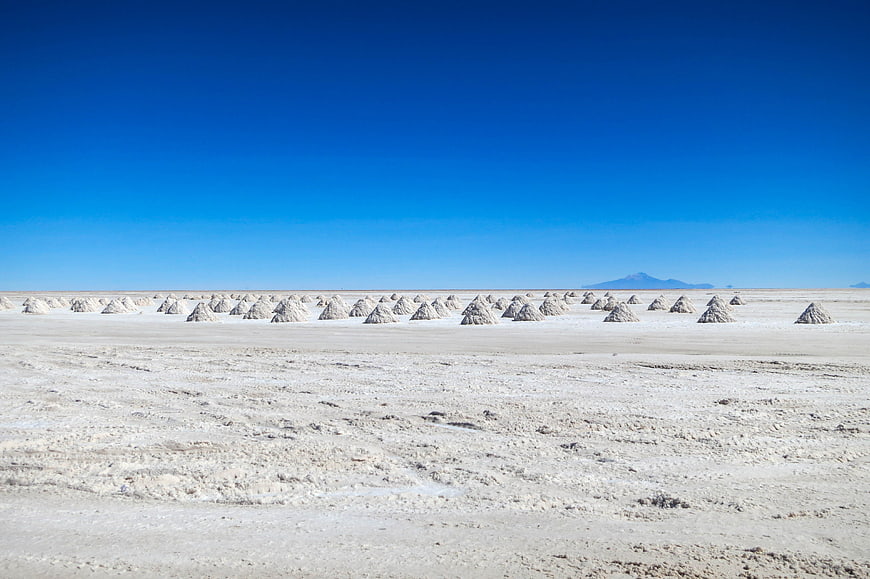 Salt Piles on Uyuni Salt Flats Under Blue Sky