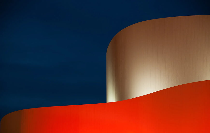 Abstract curved architectural forms in red, beige, and blue