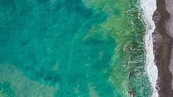 Aerial View of Turquoise Ocean Waves Crashing on Rocky Shore
