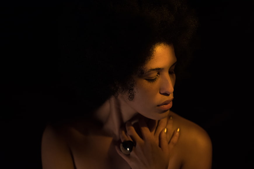 Moody Portrait of Woman with Afro and Gold Ring