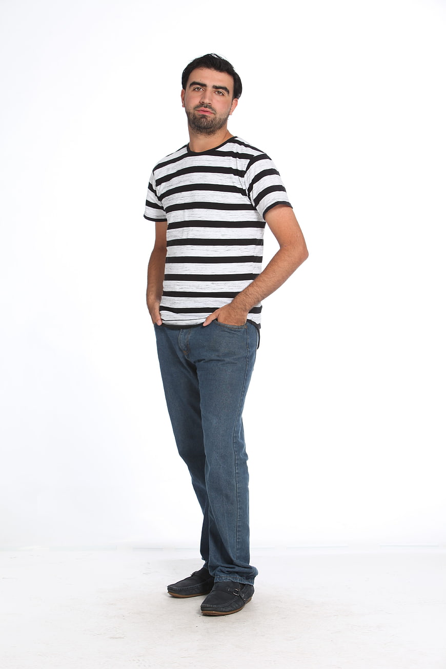 Full Body Portrait Of Man In Striped T-Shirt And Jeans