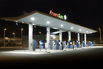 FroetGas Gas Station At Night With Illuminated Canopy And Fuel Pumps