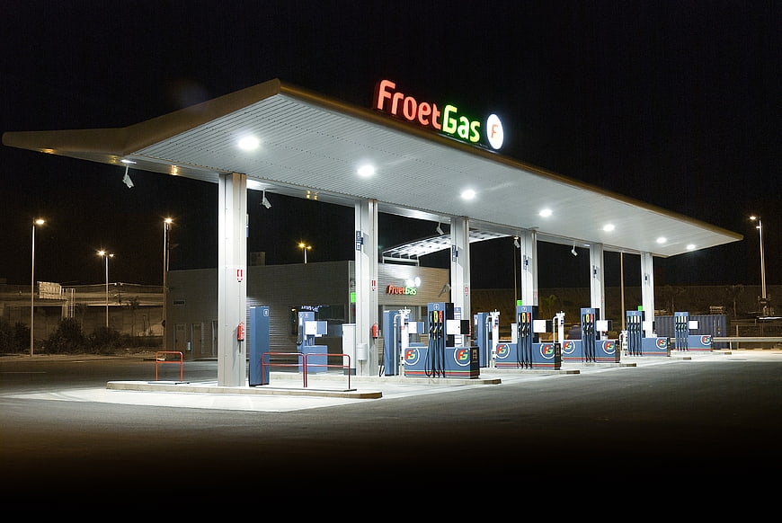 FroetGas Gas Station At Night With Illuminated Canopy And Fuel Pumps