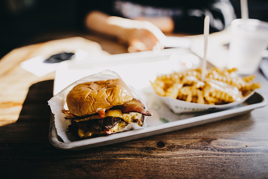 Delicious Bacon Cheeseburger and Fries on Wooden Table