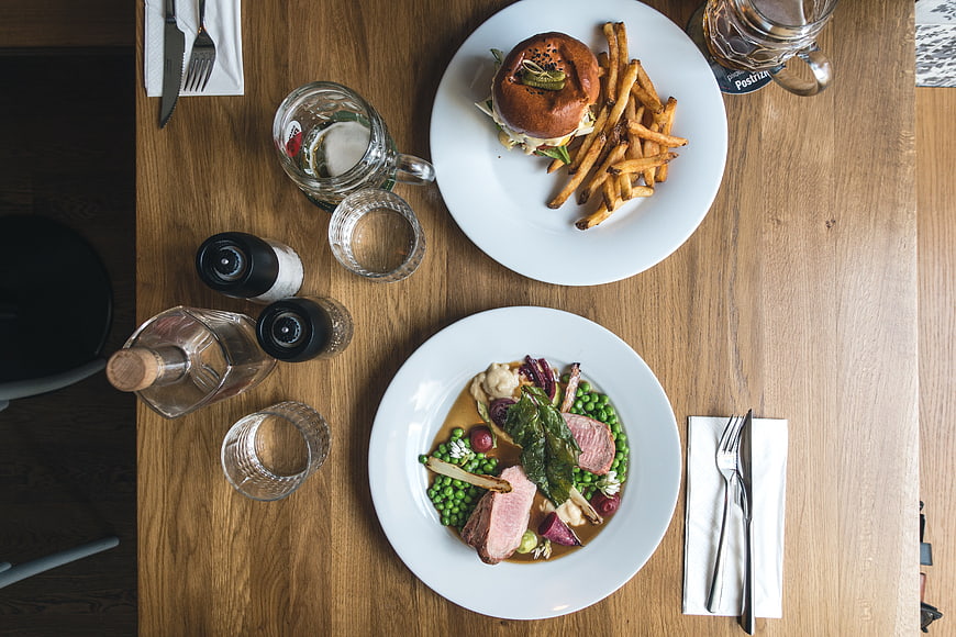 Top view of gourmet burger and pork tenderloin on wooden table