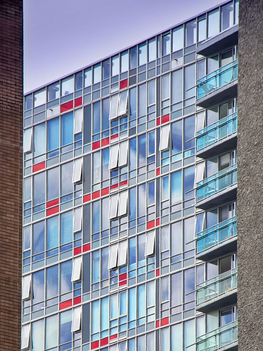 Modern Apartment Building Facade with Red and Blue Windows
