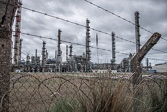 Industrial refinery plant behind barbed wire fence