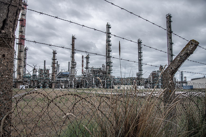 Industrial refinery plant behind barbed wire fence