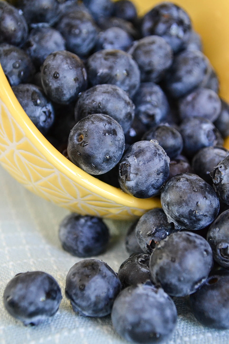 Fresh Blueberries Spilling from Yellow Bowl