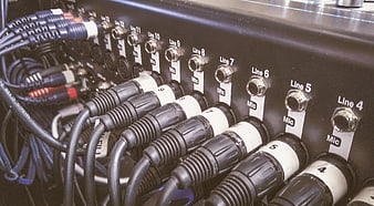 Close-up of audio mixer with connected XLR microphone cables