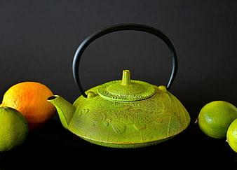Green Cast Iron Teapot with Fish Design and Citrus Fruits