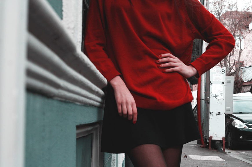 Woman in Red Sweater and Black Skirt Street Style