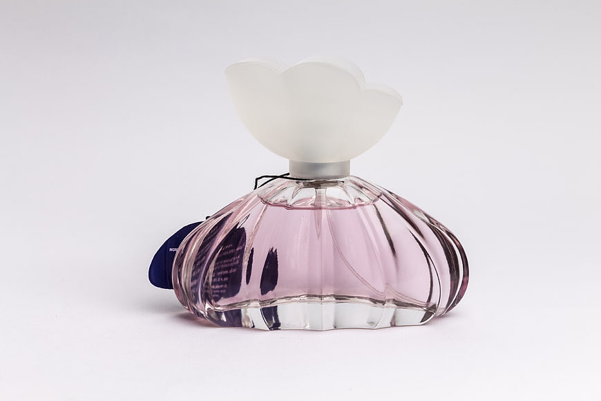 Pink Flower-Shaped Perfume Bottle on White Background
