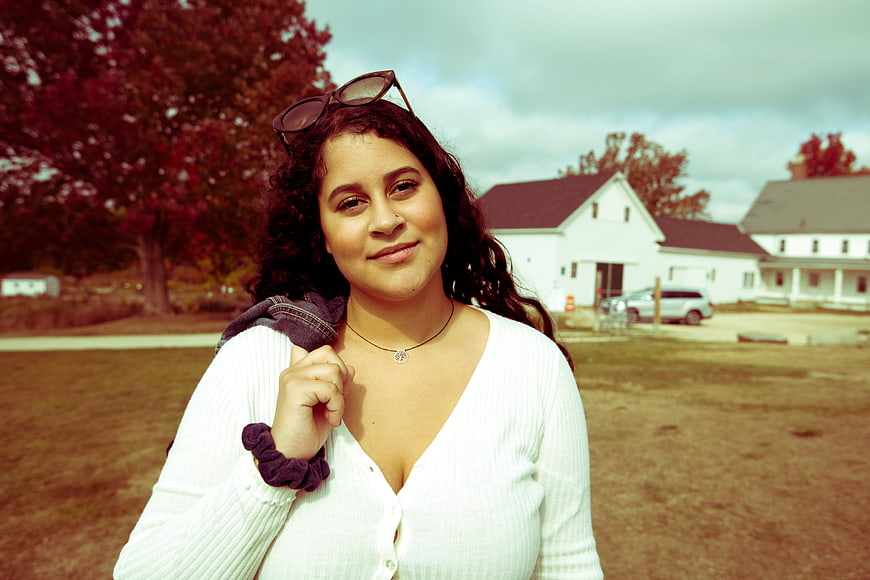 Smiling woman with curly hair outdoors in autumn