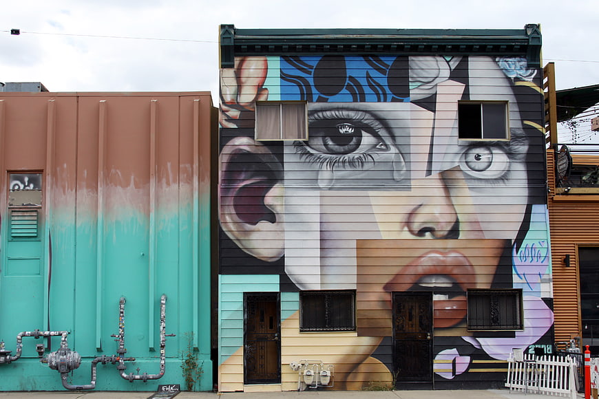 Large Street Art Mural of a Woman's Face on Urban Building