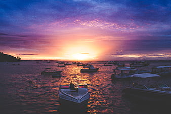 Colorful Sunset Over Harbor With Moored Fishing Boats