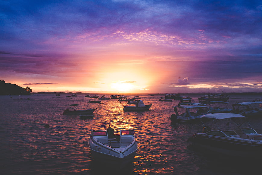 Colorful Sunset Over Harbor With Moored Fishing Boats