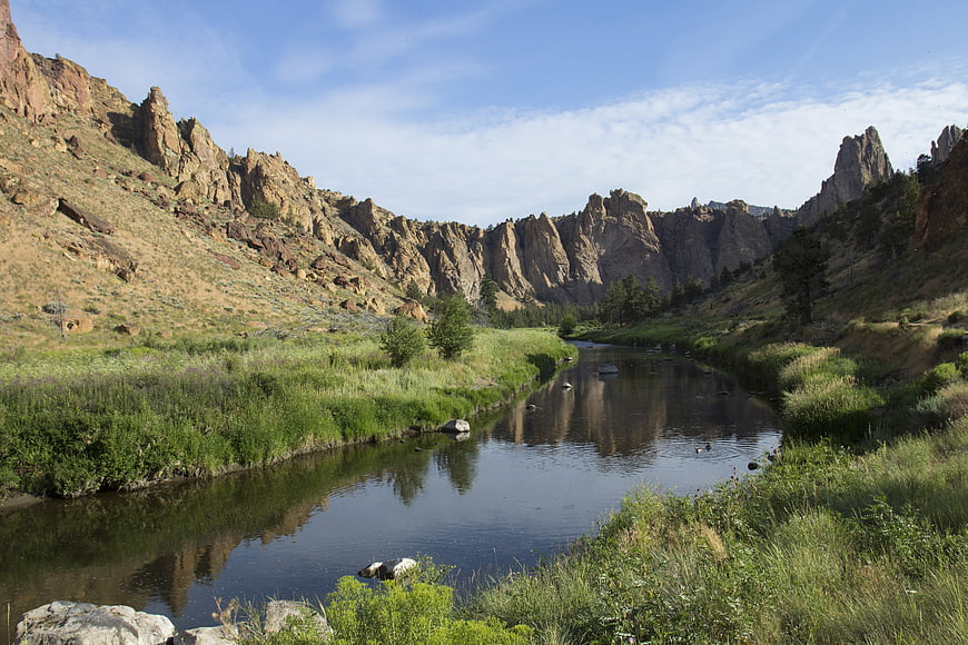Scenic river winding through rocky mountain canyon with reflections