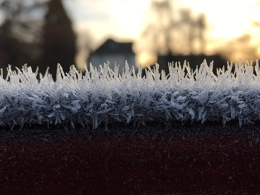 Macro Close-Up of Frost Crystals on Red Surface