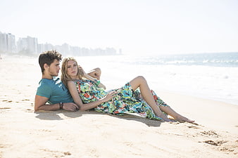 Young couple relaxing on a sunny beach in Brazil
