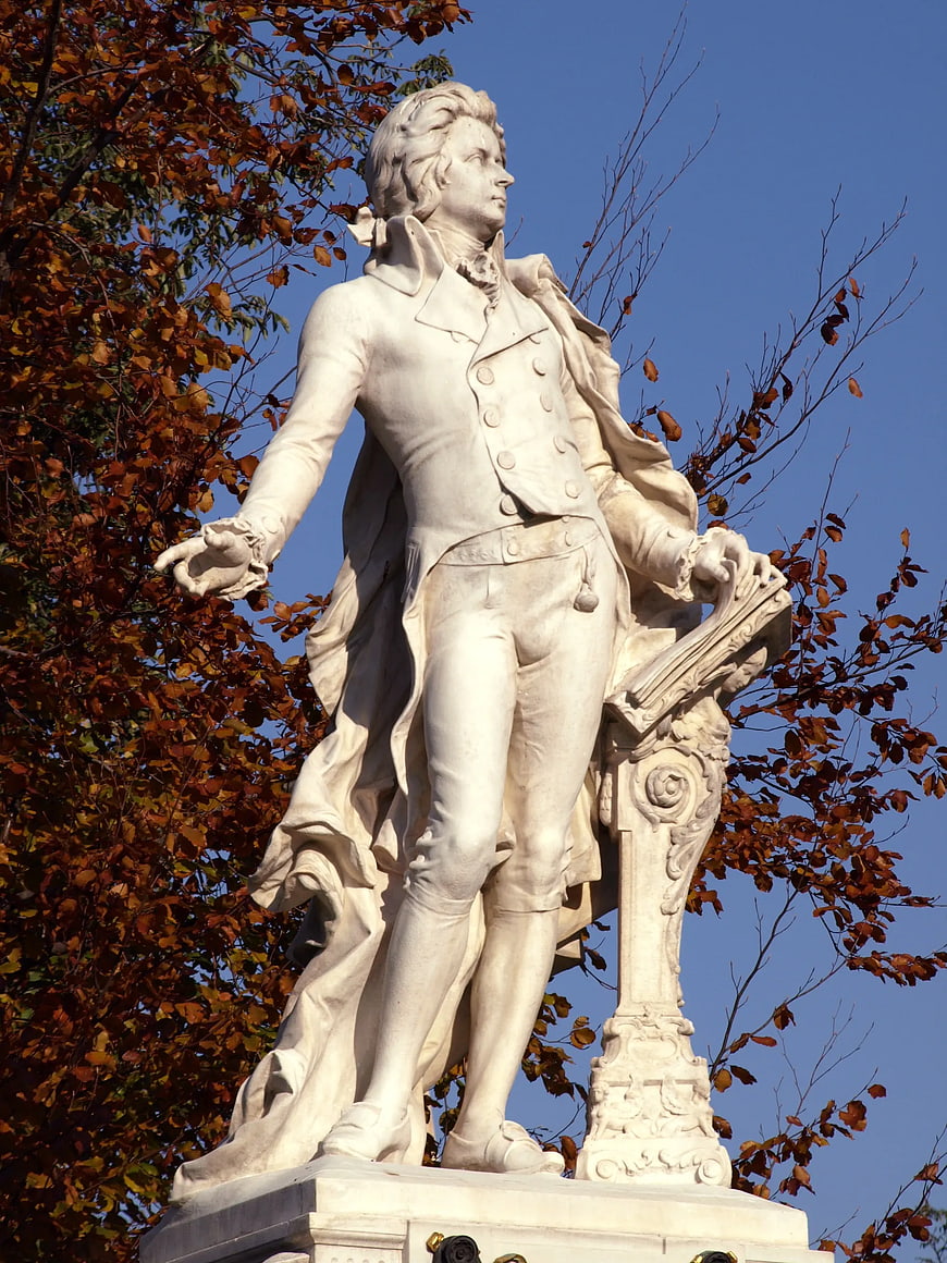 White Marble Statue of Mozart in Autumn Park