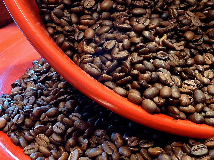 Roasted Coffee Beans Spilling from Red Bowl