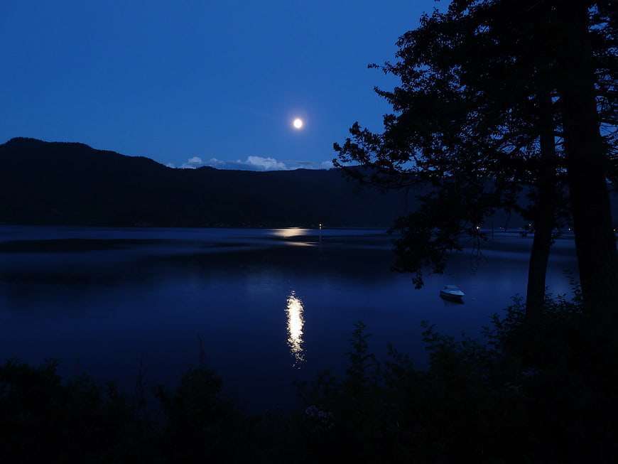 Serene Moonlit Lake Landscape with Mountain Silhouette