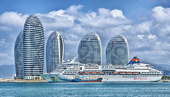 Cruise ship docked at Phoenix Island Sanya China skyline