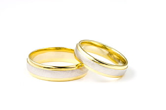 Two Gold and Silver Wedding Rings on White Background
