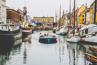 Boat cruising through colorful canal in European city