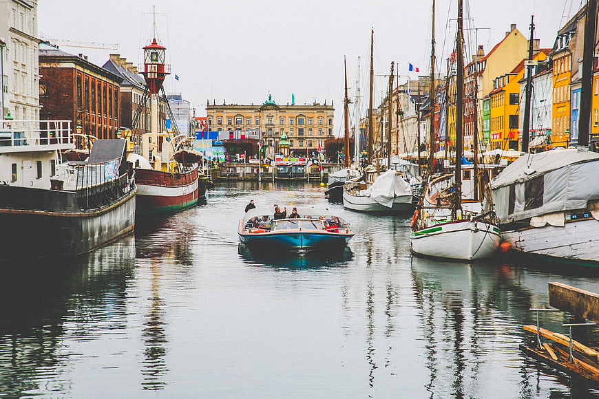 Boat cruising through colorful canal in European city