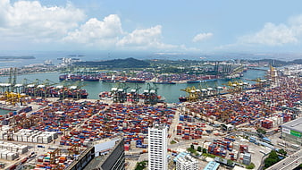 Aerial View of Busy Container Port with Ships and Cranes