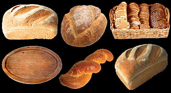 Assorted artisan bread loaves and wicker basket on black background