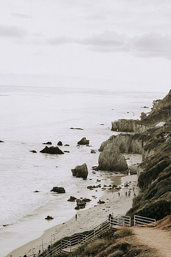 High Angle View of Rocky Beach with Cliffs and Stairs