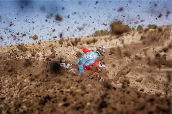 Motocross Rider Kicking Up Dirt on Track