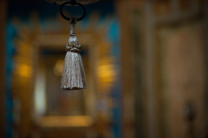 Close-up of silver tassel hanging against blurred background