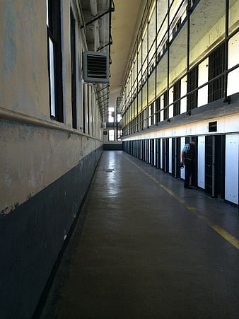 Historic Prison Cell Block Corridor With Guard