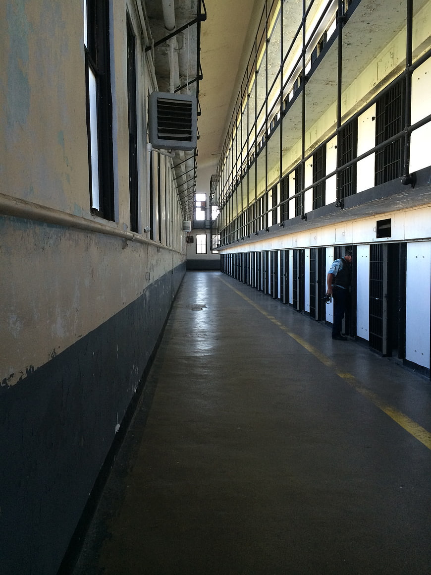 Historic Prison Cell Block Corridor With Guard