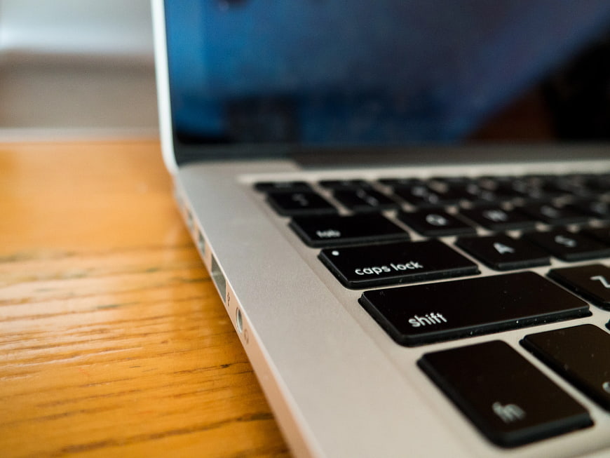 Close-up of Laptop Keyboard on Wooden Desk