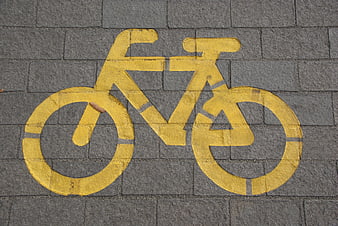 Yellow Bicycle Lane Symbol on Gray Paved Road
